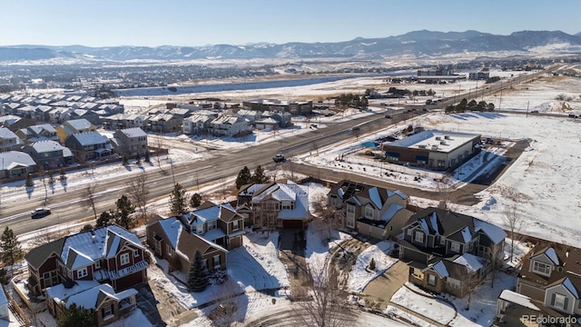 snowy aerial view featuring a mountain view