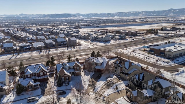 snowy aerial view featuring a mountain view