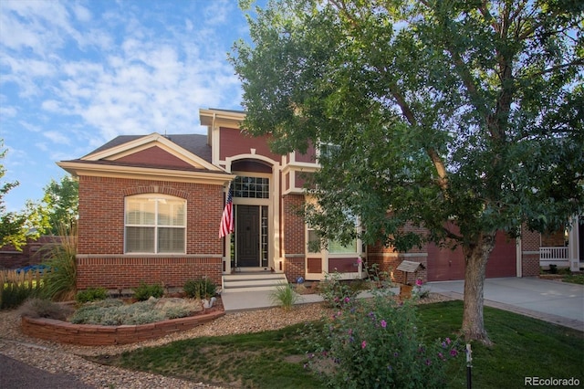 view of front of house featuring brick siding, an attached garage, and concrete driveway