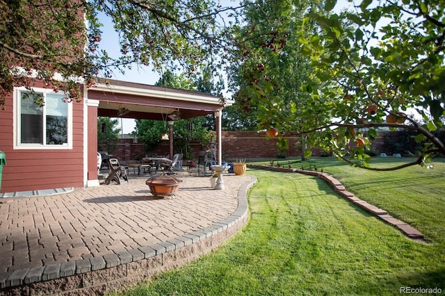 view of yard with a patio area and an outdoor fire pit