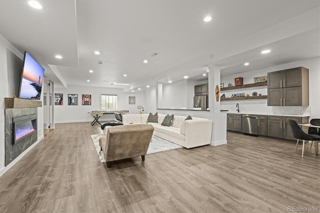 8023 Gore Creek Ln, Littleton, CO 80125 - living room with light wood-style flooring, recessed lighting, a fireplace, and baseboards