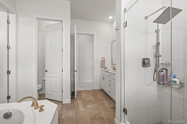 8023 Gore Creek Ln, Littleton, CO 80125 - bathroom with vanity, a stall shower, toilet, and recessed lighting