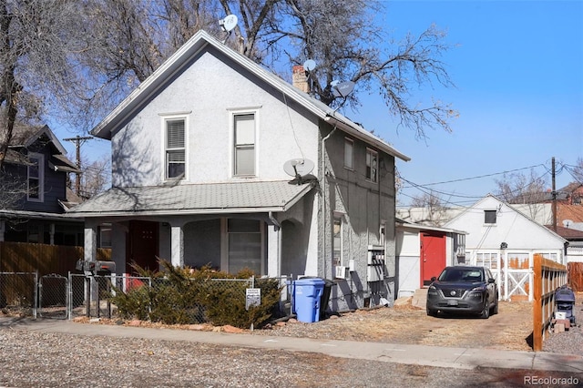 view of front of property with a porch, fence, a chimney, and stucco siding