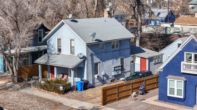 view of front of home featuring covered porch, a fenced front yard, and stucco siding