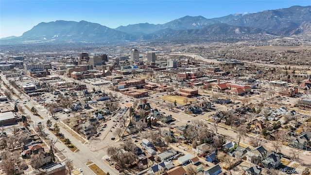 drone / aerial view featuring a city view and a mountain view