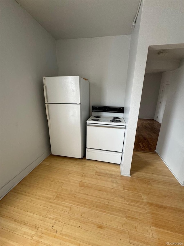 kitchen featuring white appliances and light wood-type flooring