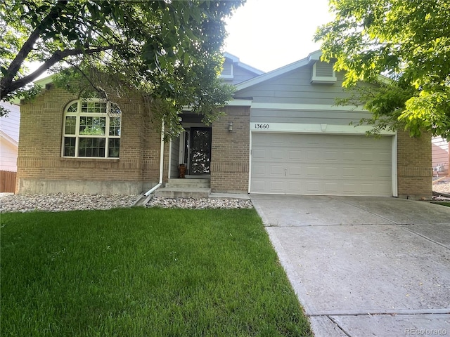 13660 Monroe St, Thornton, CO 80602 - view of property hidden behind natural elements with driveway, a front lawn, brick siding, and a garage