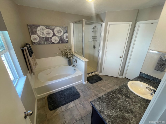 13660 Monroe St, Thornton, CO 80602 - bathroom with a shower stall, vanity, a garden tub, and tile patterned flooring