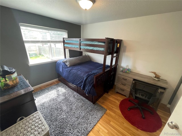 13660 Monroe St, Thornton, CO 80602 - bedroom with wood finished floors and a textured ceiling