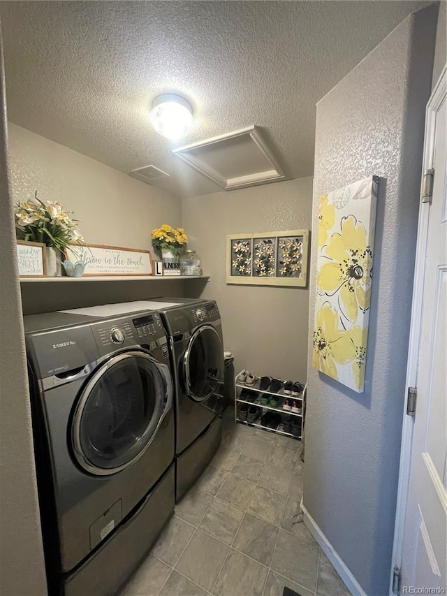13660 Monroe St, Thornton, CO 80602 - laundry area with washing machine and dryer, attic access, a textured ceiling, a textured wall, and tile patterned flooring