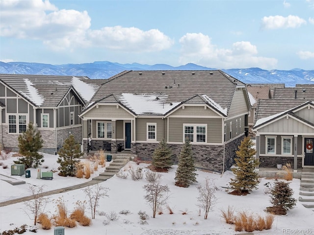 view of front of property with stone siding and a mountain view