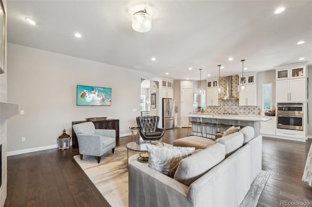 living room featuring hardwood / wood-style flooring, a fireplace, and sink