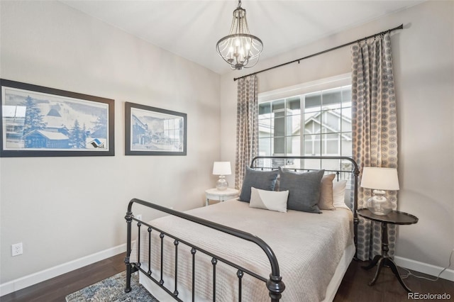 bedroom featuring dark hardwood / wood-style floors and a chandelier