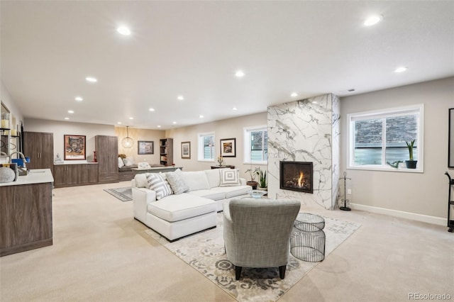 carpeted living room featuring a premium fireplace