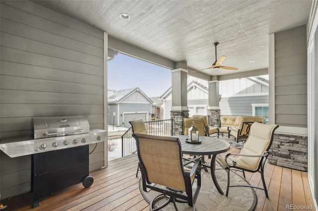 wooden deck with an outdoor living space, area for grilling, and ceiling fan