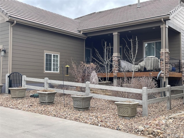 exterior space featuring fence and covered porch