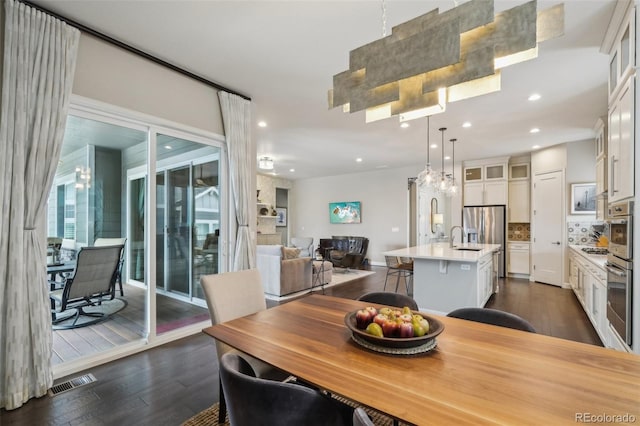 dining area featuring dark wood-style floors, visible vents, and recessed lighting