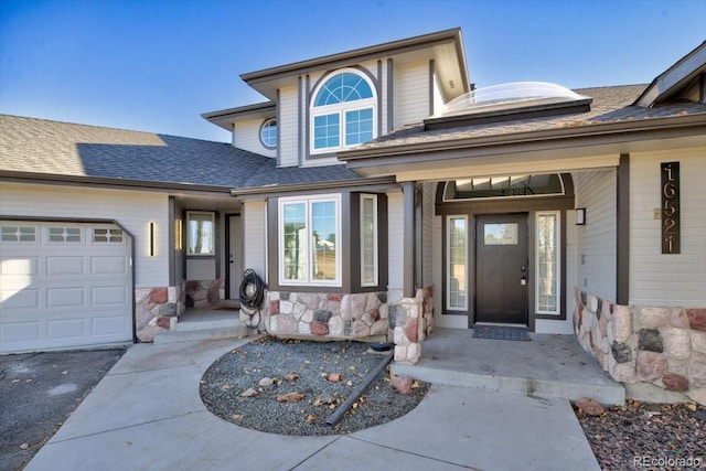 doorway to property with a garage