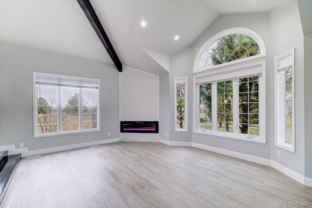 unfurnished living room with light hardwood / wood-style flooring, beamed ceiling, and high vaulted ceiling