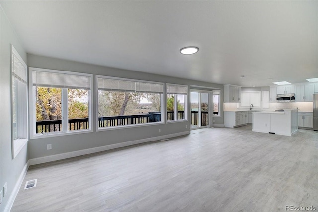 unfurnished living room featuring light wood-type flooring