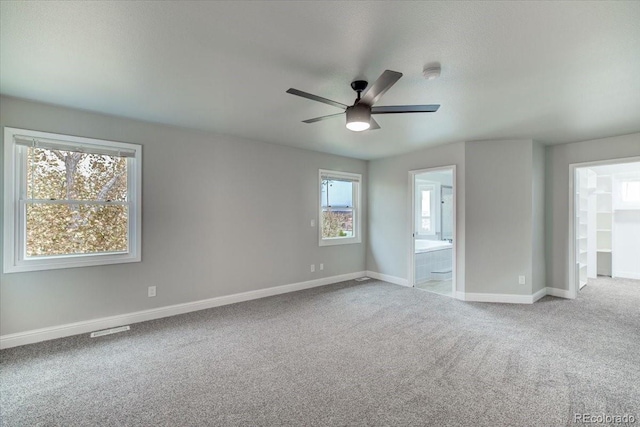 carpeted spare room with ceiling fan