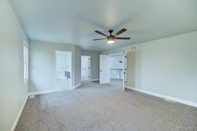 unfurnished bedroom with connected bathroom, ceiling fan, and light carpet