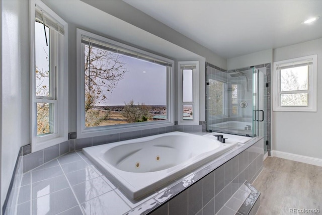 bathroom featuring hardwood / wood-style flooring, plenty of natural light, and shower with separate bathtub