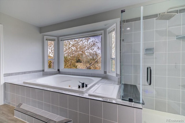 bathroom featuring separate shower and tub and wood-type flooring