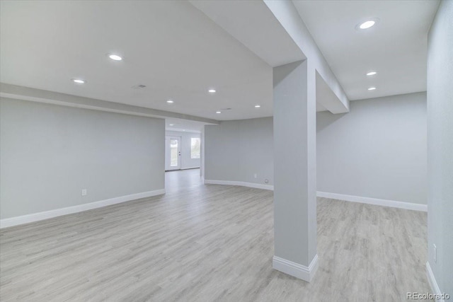 basement with light hardwood / wood-style flooring