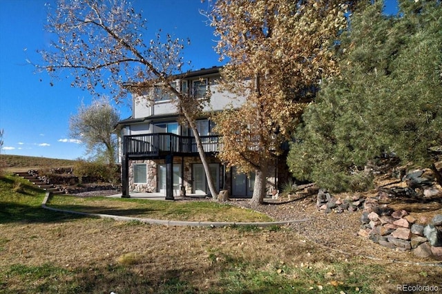 back of house featuring a deck