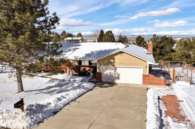 ranch-style home featuring a garage and a mountain view