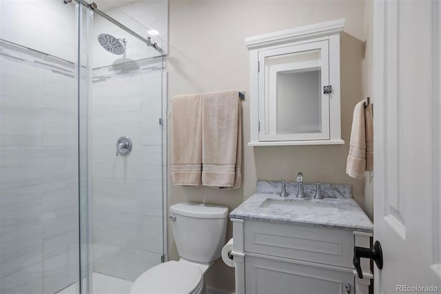 bathroom featuring vanity, toilet, and walk in shower