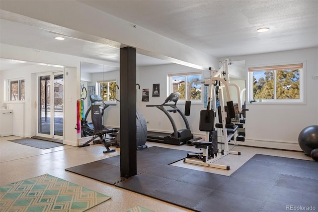 workout room with a textured ceiling