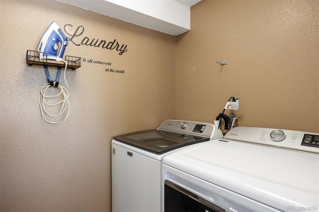 clothes washing area with washer and dryer