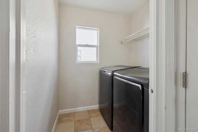 clothes washing area with laundry area, independent washer and dryer, and baseboards