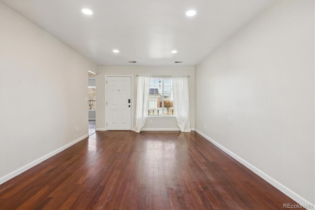 interior space with visible vents, baseboards, dark wood-style flooring, and recessed lighting