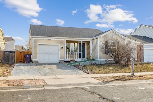 ranch-style home featuring a porch, a shingled roof, fence, a garage, and driveway