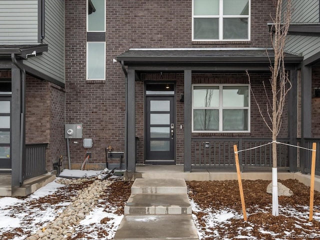 view of snow covered property entrance