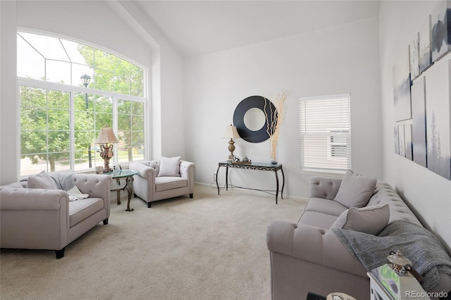 carpeted living room featuring lofted ceiling