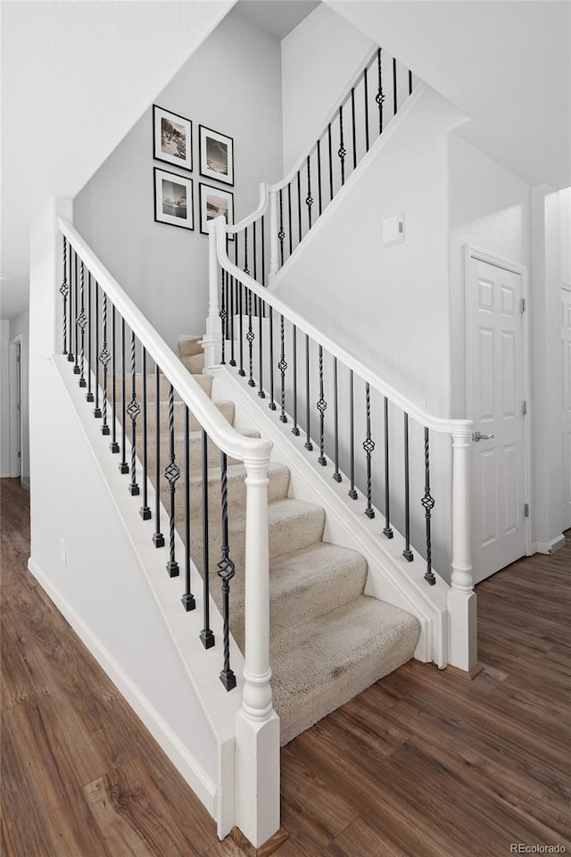 stairs featuring hardwood / wood-style flooring