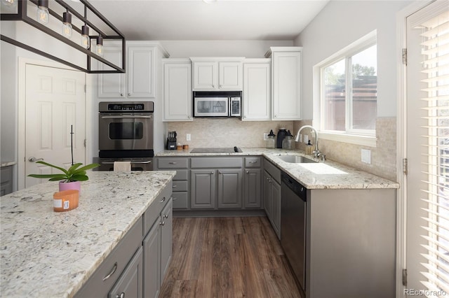 kitchen with sink, decorative backsplash, dark wood-type flooring, and stainless steel appliances