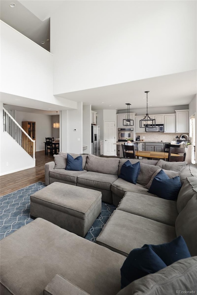 living room featuring dark hardwood / wood-style flooring and a high ceiling