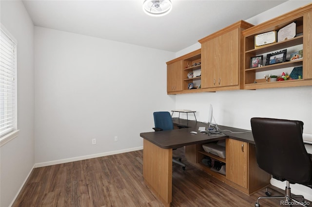 home office with dark hardwood / wood-style floors