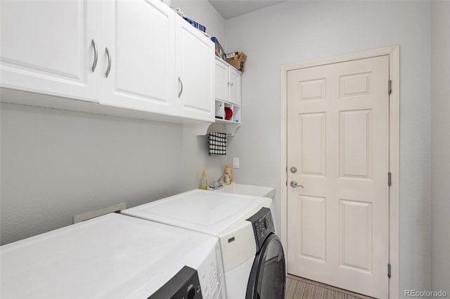 laundry room with dark wood-type flooring, cabinets, washer and clothes dryer, and sink