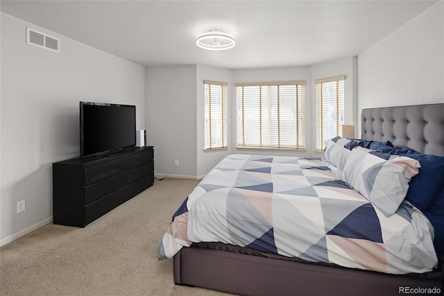 bedroom featuring light colored carpet