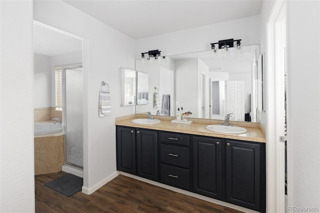 bathroom featuring vanity, wood-type flooring, and independent shower and bath