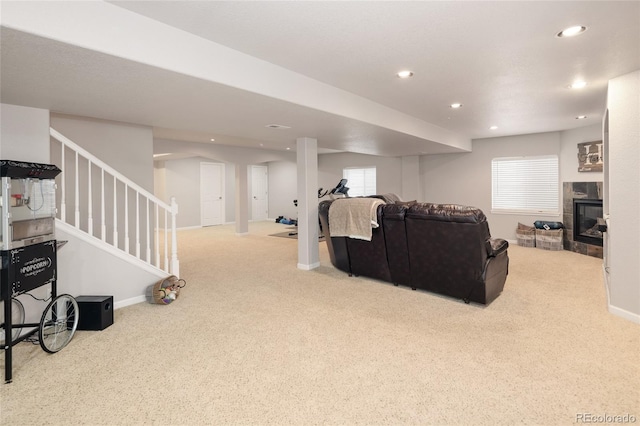 carpeted living room featuring a tile fireplace