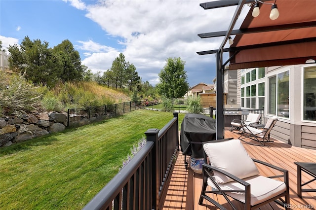 wooden terrace with area for grilling and a yard