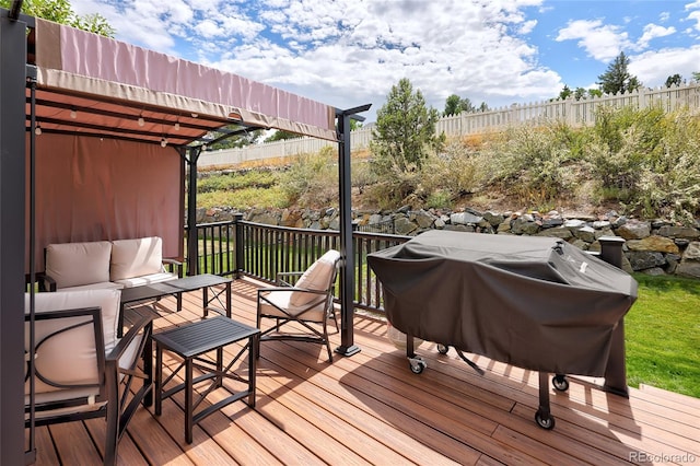 wooden terrace featuring outdoor lounge area and area for grilling