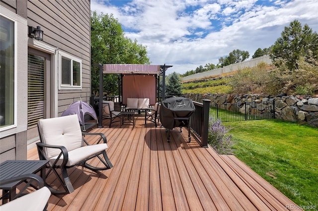 wooden terrace featuring a grill and a lawn